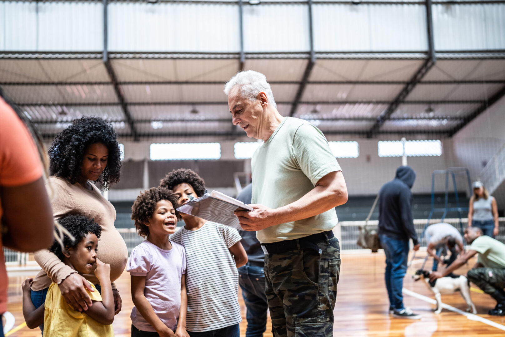 Group of people gathered in a gymnasium.