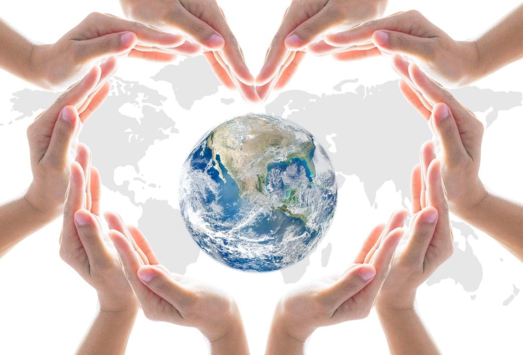h2 (2) Hands forming heart around Earth globe.
